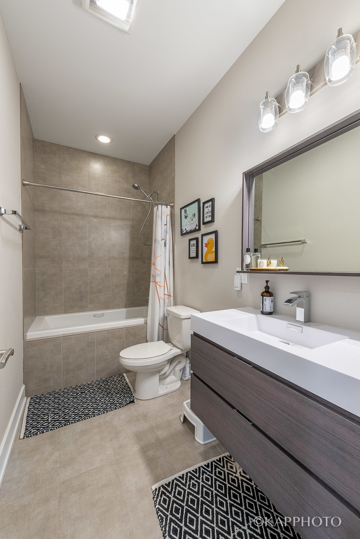 1430 West Fillmore Street, Unit 2W Chicago, IL 60607 - Photo 24 of 27 a bathroom with a sink a toilet and shower