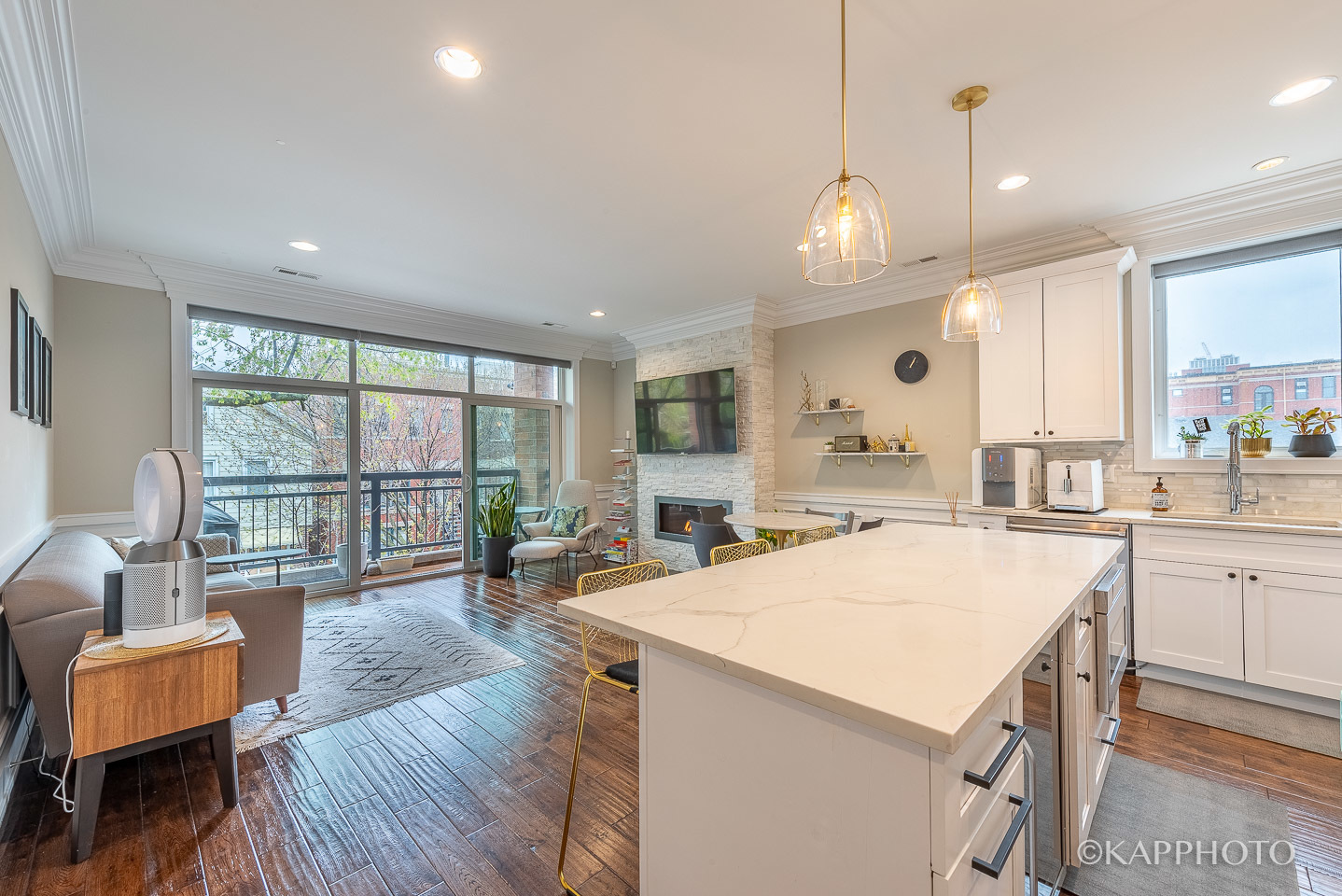 1430 West Fillmore Street, Unit 2W Chicago, IL 60607 - Photo 8 of 27 a large kitchen with dishwasher a stove a dining table and chairs with wooden floor