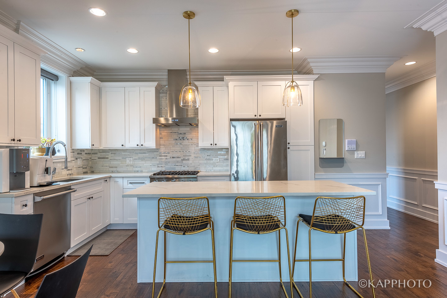 1430 West Fillmore Street, Unit 2W Chicago, IL 60607 - Photo 10 of 27 a kitchen with stainless steel appliances kitchen island granite countertop a table chairs sink and refrigerator