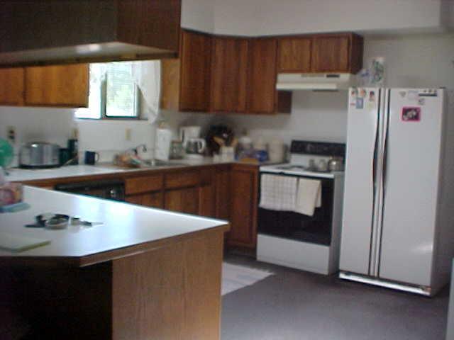 14040 Rutherford Road Yakima, WA 98903 - Photo 3 of 7 a kitchen with stainless steel appliances a sink a stove a refrigerator and cabinets