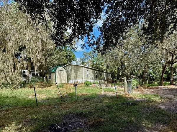 a backyard of apartments with large trees