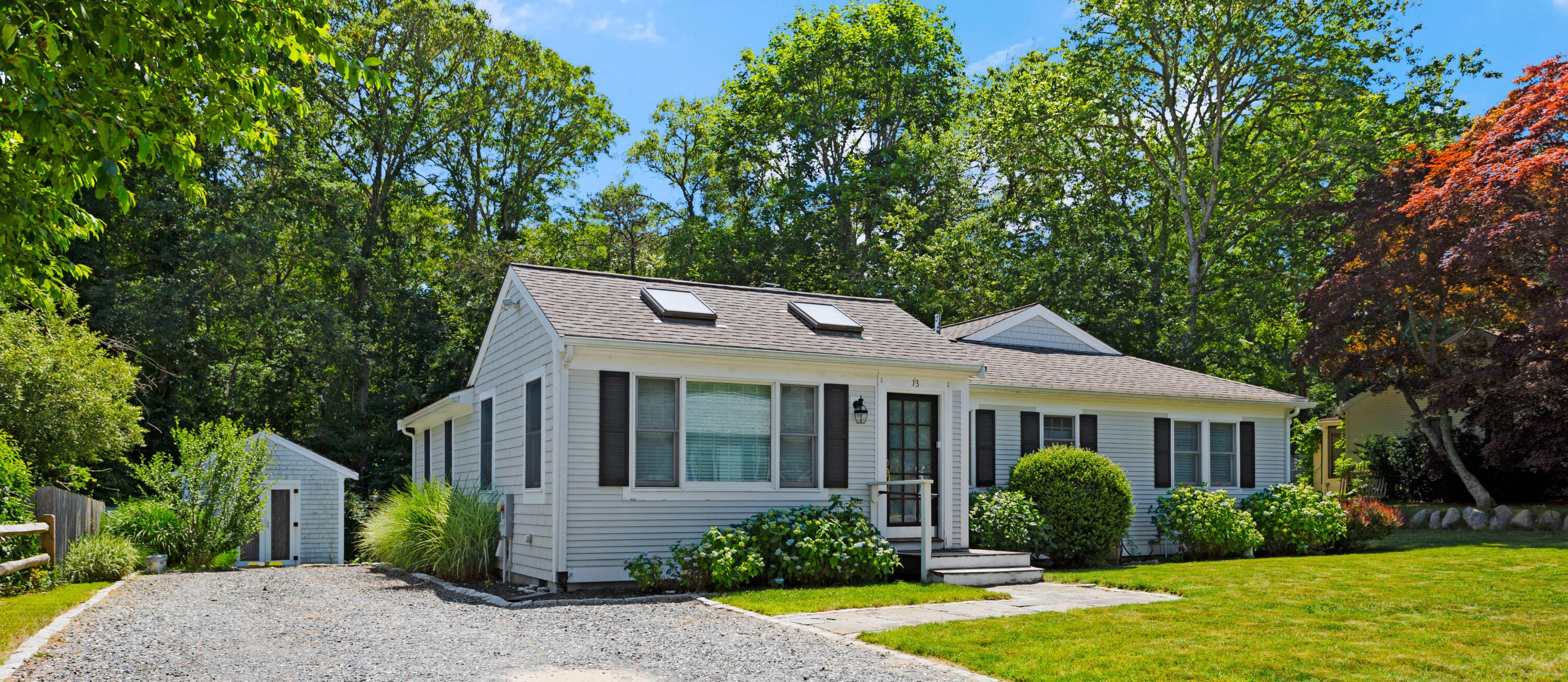 13 Johnny Cake Road Centerville, MA 02632 - Photo 1 of 40 a front view of a house with garden and porch