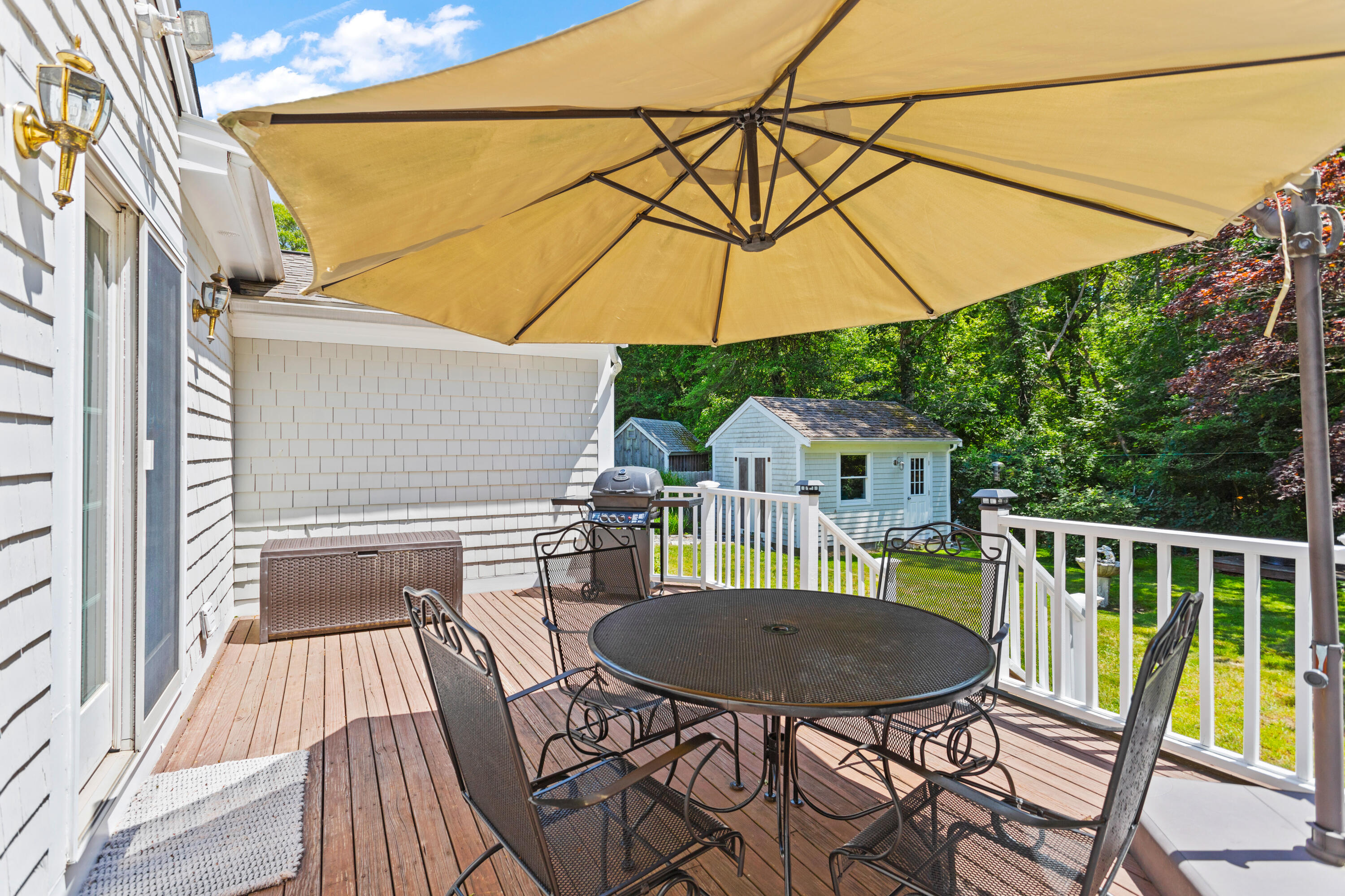 13 Johnny Cake Road Centerville, MA 02632 - Photo 16 of 40 a backyard of a house with table and chairs