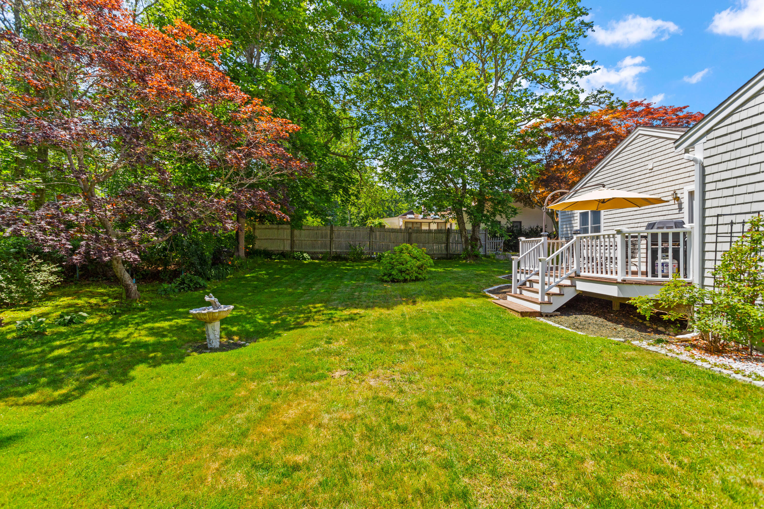 13 Johnny Cake Road Centerville, MA 02632 - Photo 17 of 40 a view of a house with a big yard potted plants and large tree