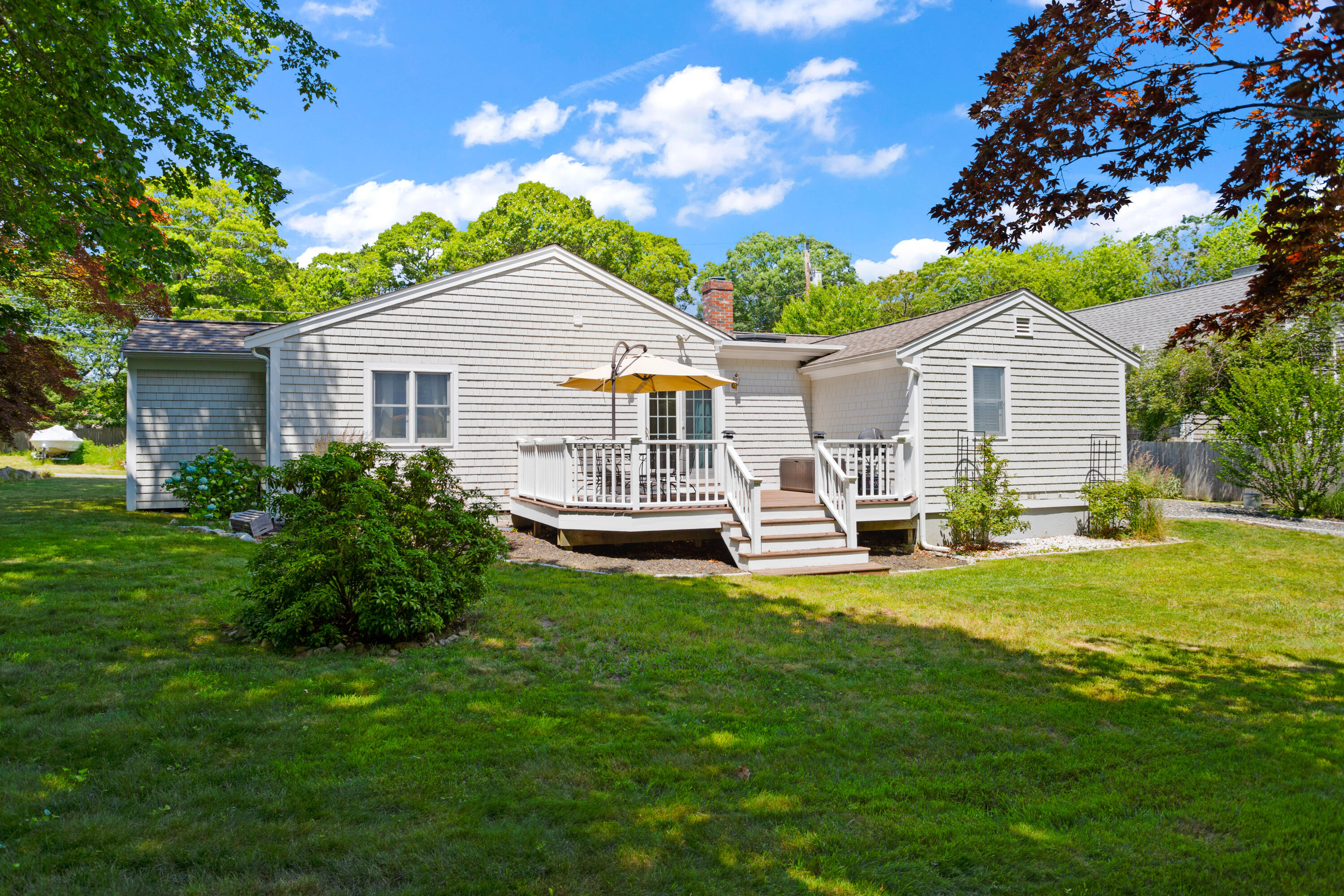 13 Johnny Cake Road Centerville, MA 02632 - Photo 35 of 40 a view of a house with a yard porch and sitting area