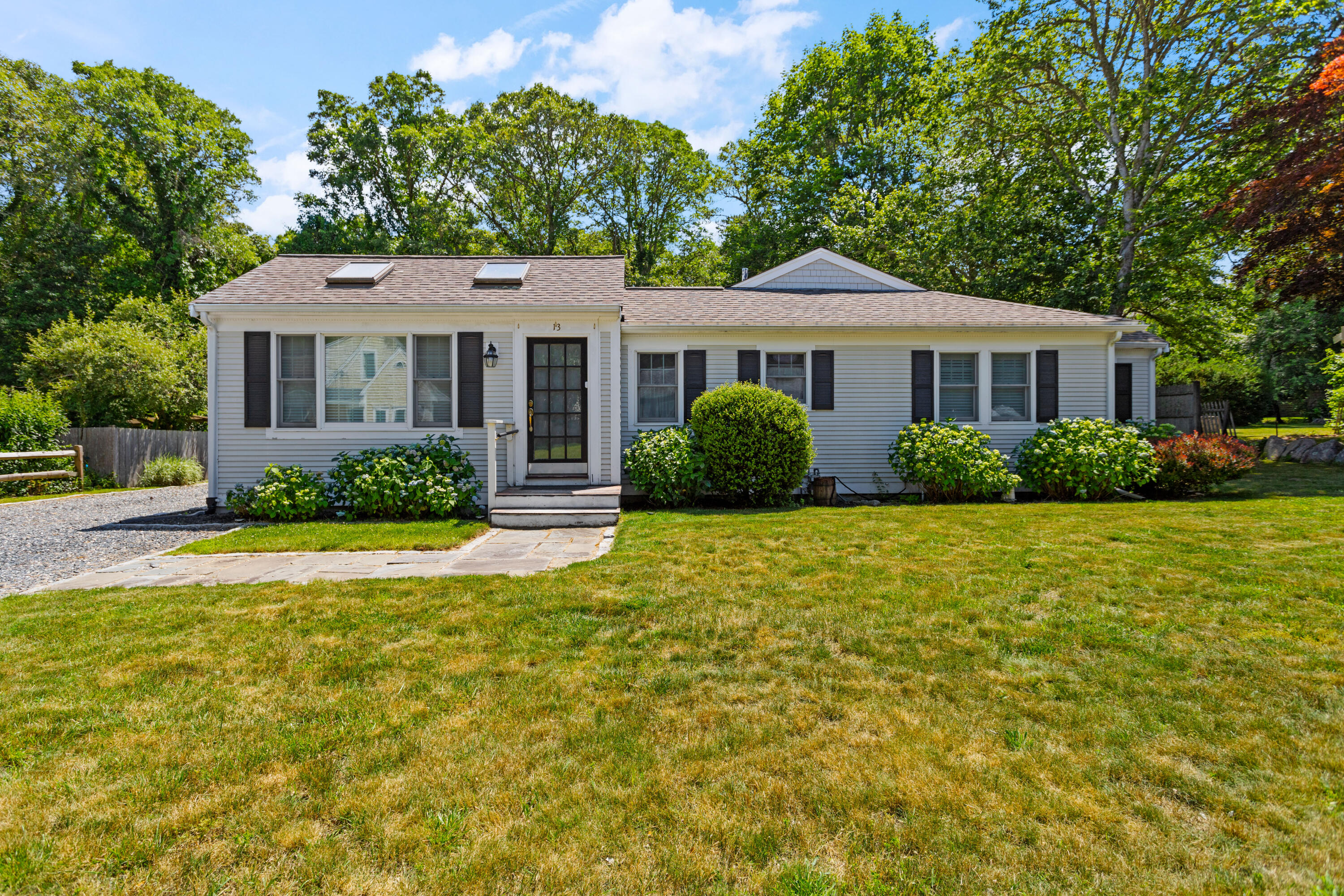 13 Johnny Cake Road Centerville, MA 02632 - Photo 7 of 40 a front view of a house with a yard and potted plants