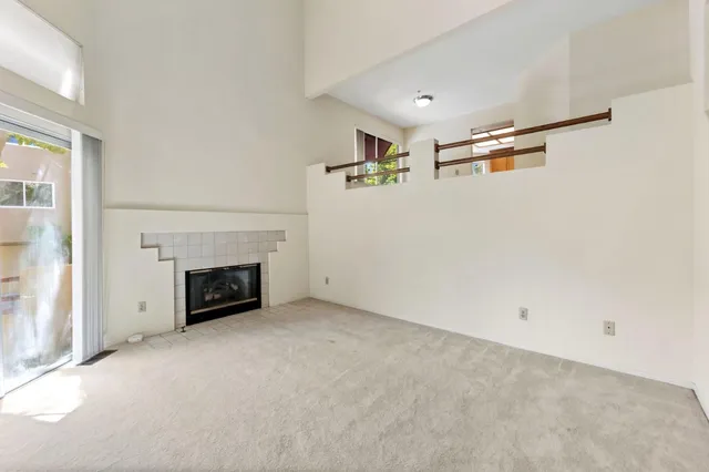 a view of empty room with a fireplace