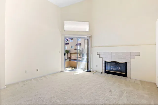 a view of a livingroom with a fireplace and a window