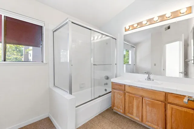a bathroom with a double vanity sink mirror and double