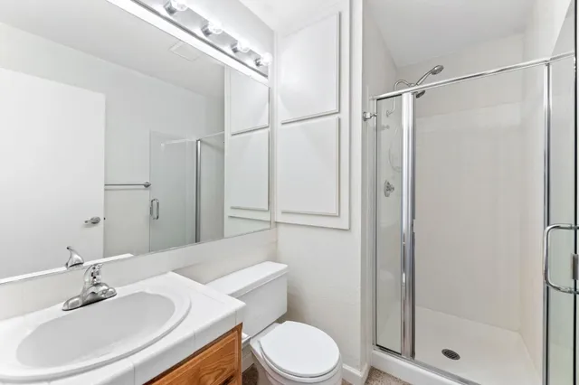 a bathroom with a sink toilet and shower