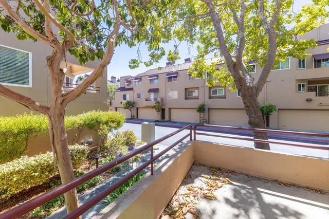 a view of a house with a large tree