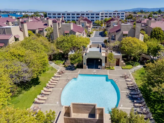 a aerial view of a swimming pool and mountain view