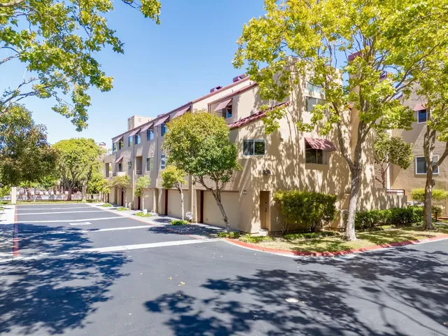 a street sign on a sidewalk next to a road