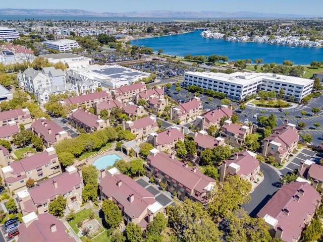 an aerial view of residential houses with outdoor space