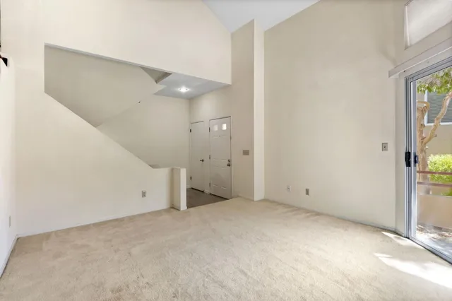 an empty room with windows and entrance