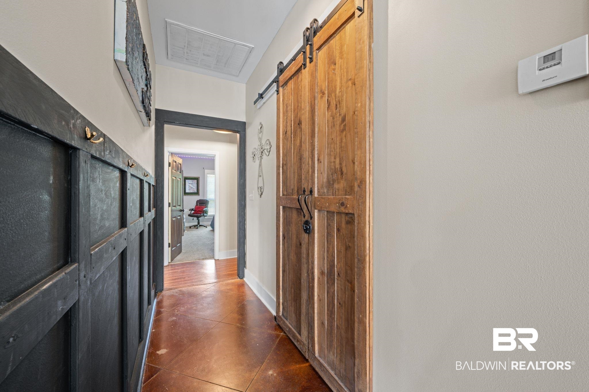 15635 North A N Brady Road Bay Minette, AL 36507 - Photo 19 of 51 Corridor featuring a barn door and dark tile patterned flooring