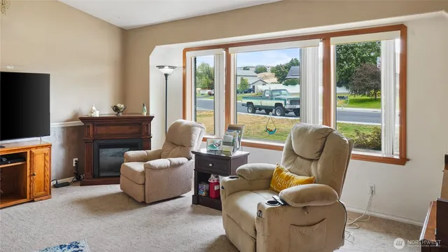 a balcony with a potted plant on a table and a potted plant
