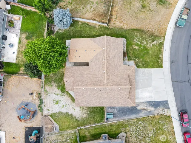 an aerial view of a house with a yard