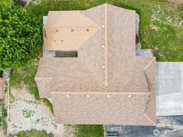 a blue couch sitting in a living room next to a window