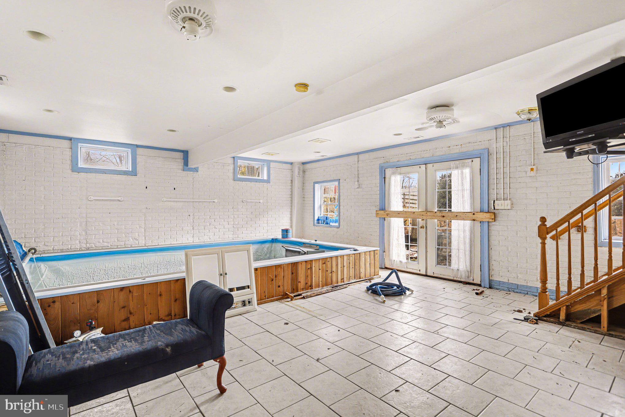 10301 Mckinstry Mill Road New Windsor, MD 21776 - Photo 13 of 43 Indoor therapy pool, doors to back patio