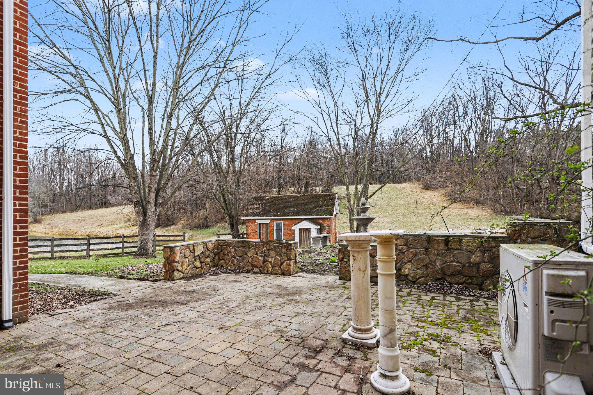 10301 Mckinstry Mill Road New Windsor, MD 21776 - Photo 18 of 43 Side patio facing spring house