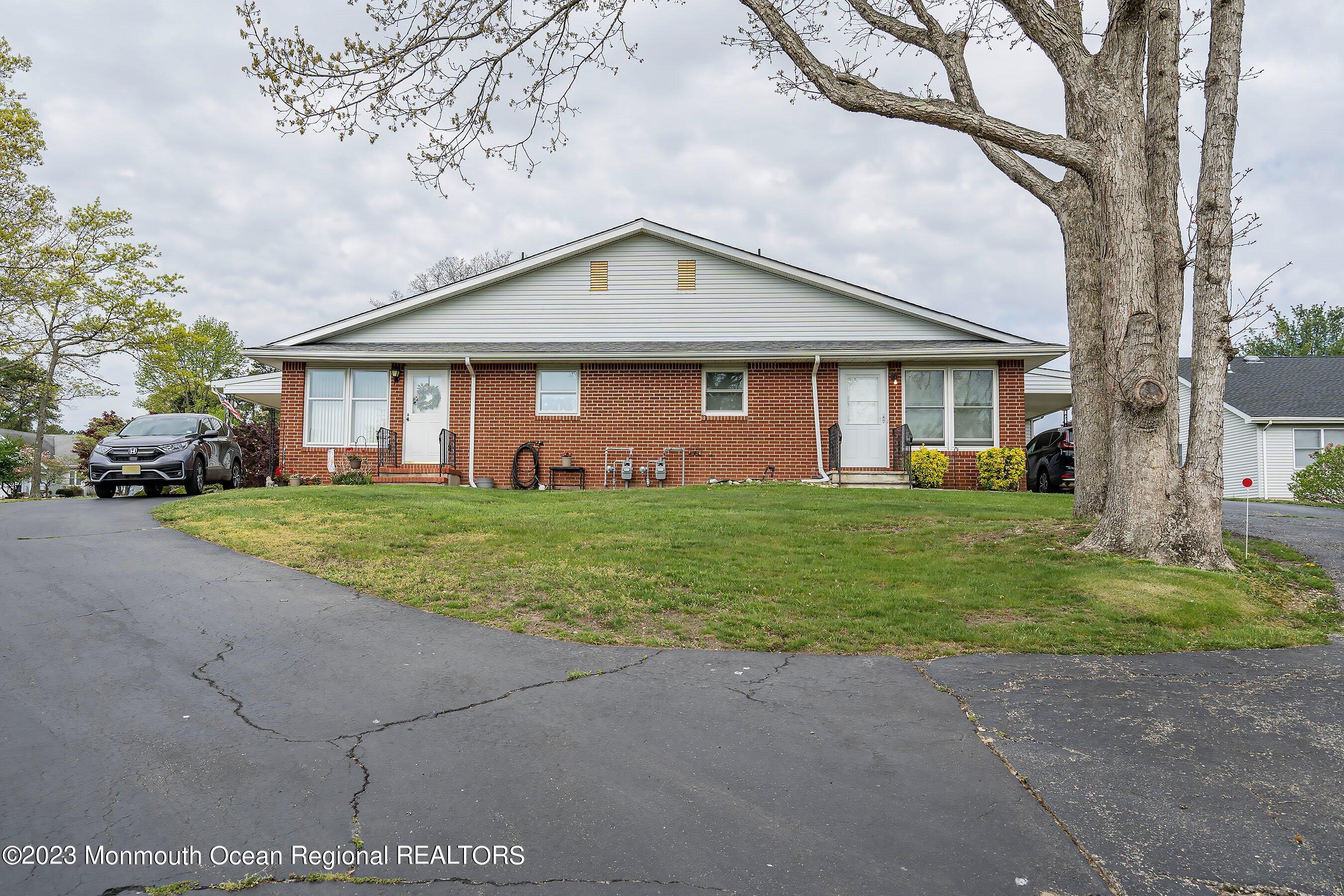 16 B Magnolia Road, Unit 1A Manahawkin, NJ 08050 - Photo 1 of 21 a front view of house with yard and green space