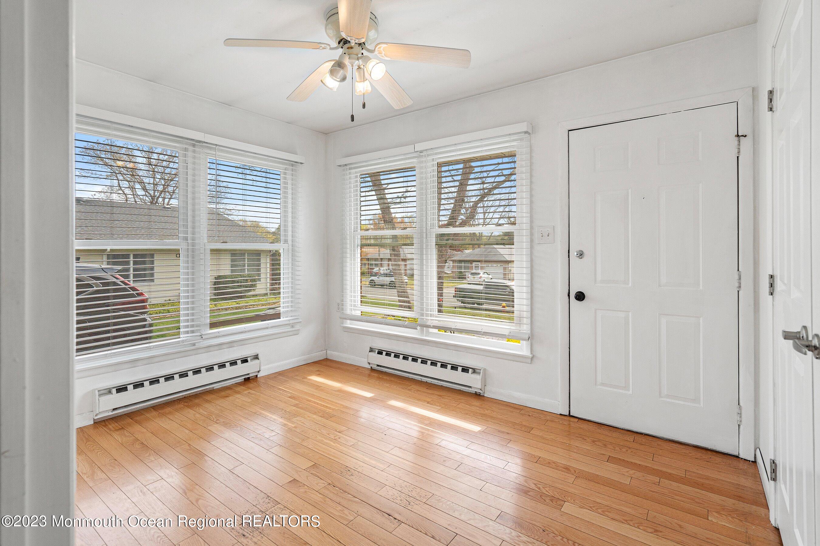 16 B Magnolia Road, Unit 1A Manahawkin, NJ 08050 - Photo 6 of 21 a view of an empty room with a window and wooden floor