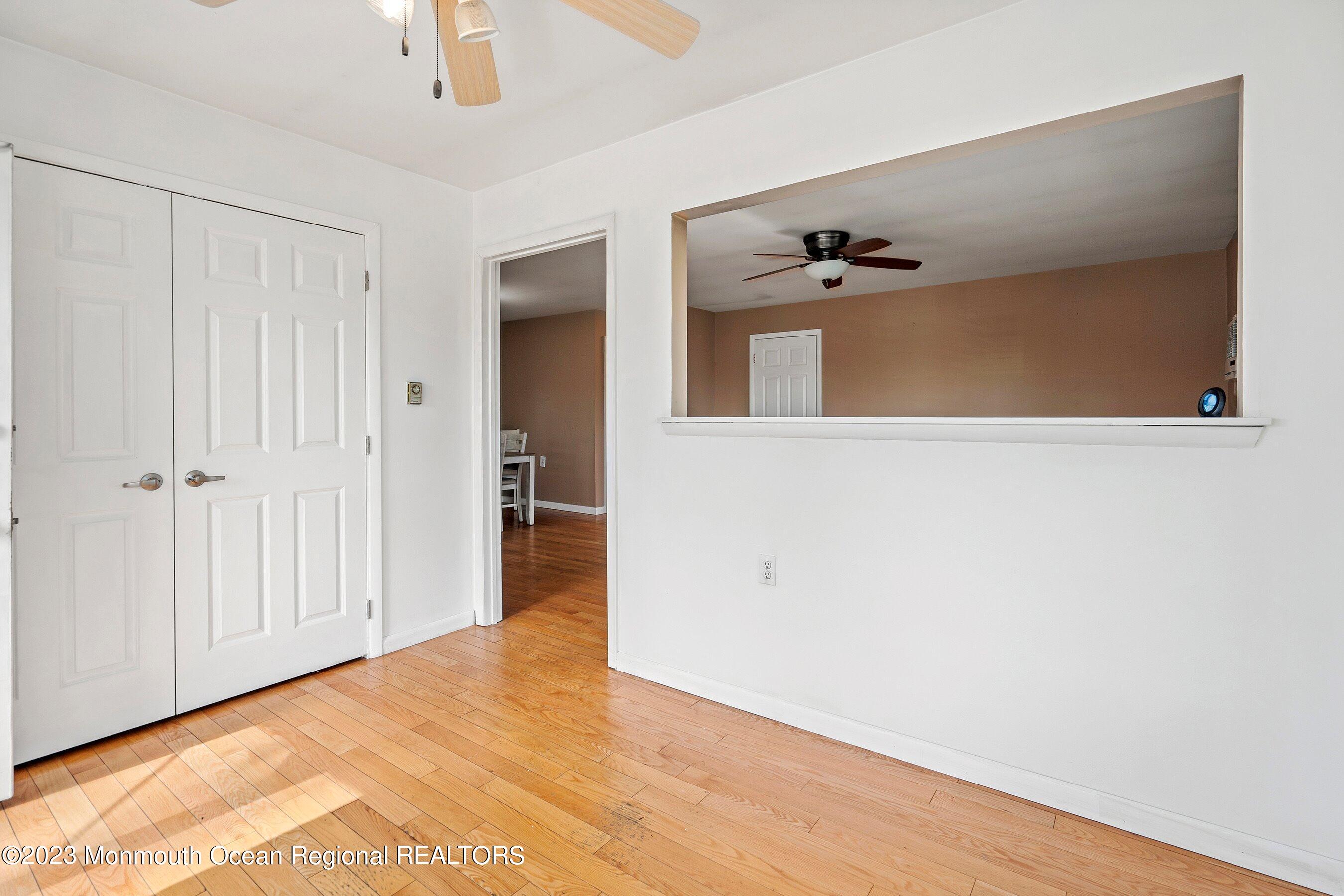 16 B Magnolia Road, Unit 1A Manahawkin, NJ 08050 - Photo 8 of 21 a view of a hallway with wooden floor and chandelier