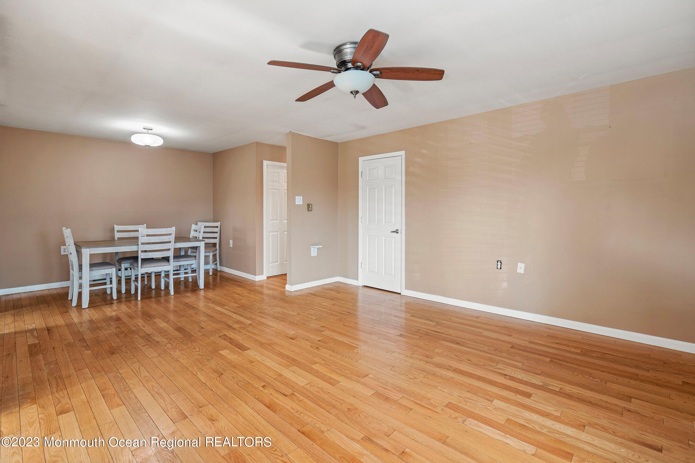 16 B Magnolia Road, Unit 1A Manahawkin, NJ 08050 - Photo 10 of 21 a view of workspace with wooden floor and chandelier fan