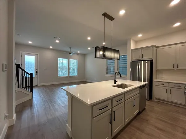 a kitchen with a refrigerator stove and sink