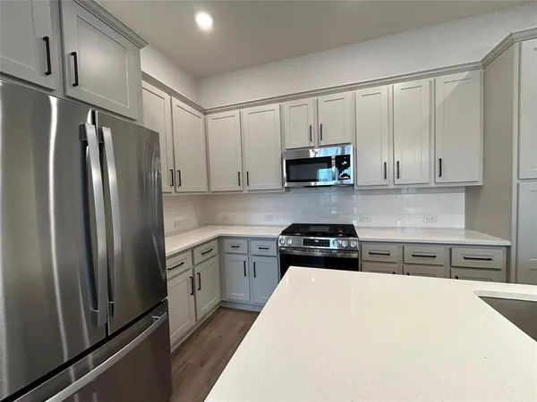 a bathroom with a granite countertop toilet sink and mirror