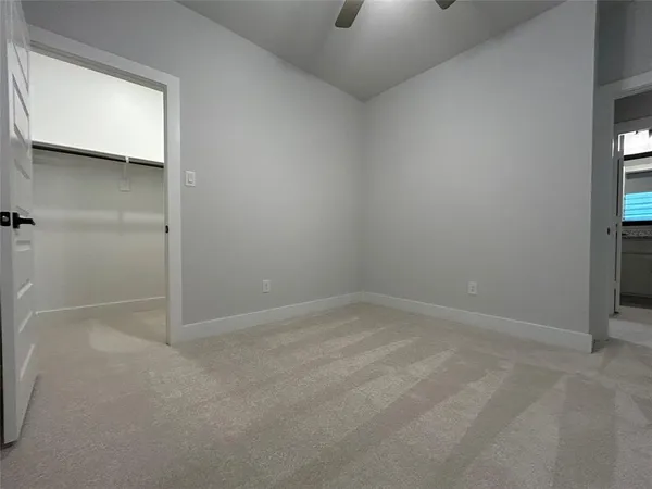 an empty room with projector & windows