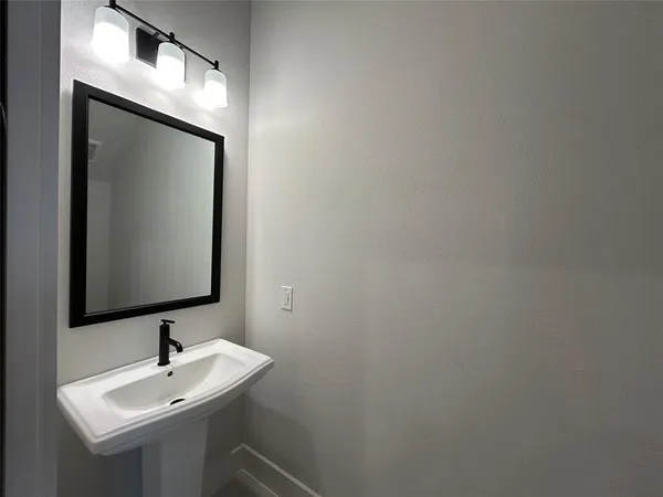 a living room with stainless steel appliances kitchen island a large counter top and a wooden floor