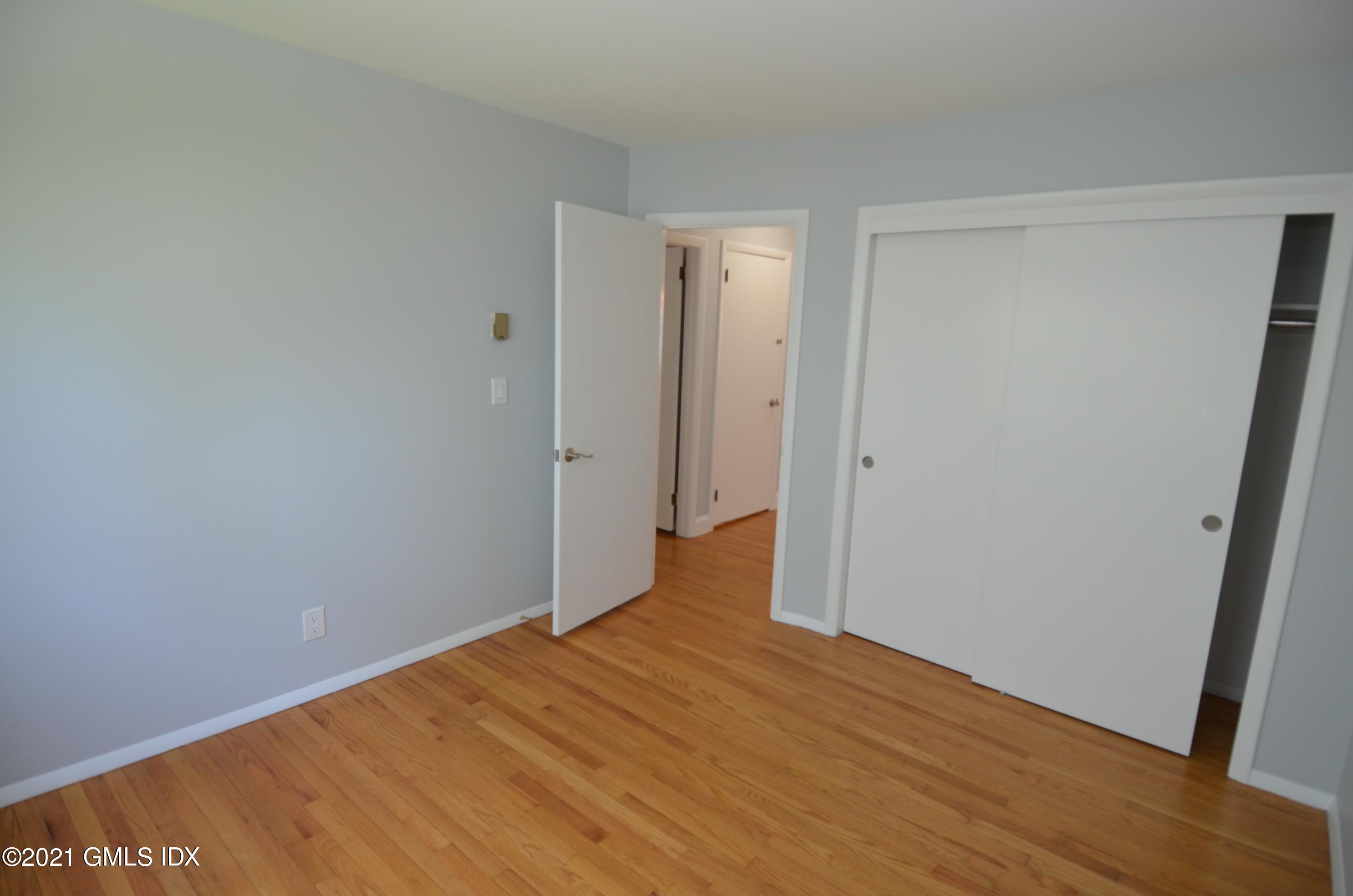 5 Ridge Place, Unit 1 Greenwich, CT 06831 - Photo 11 of 29 a view of an empty room with wooden floor
