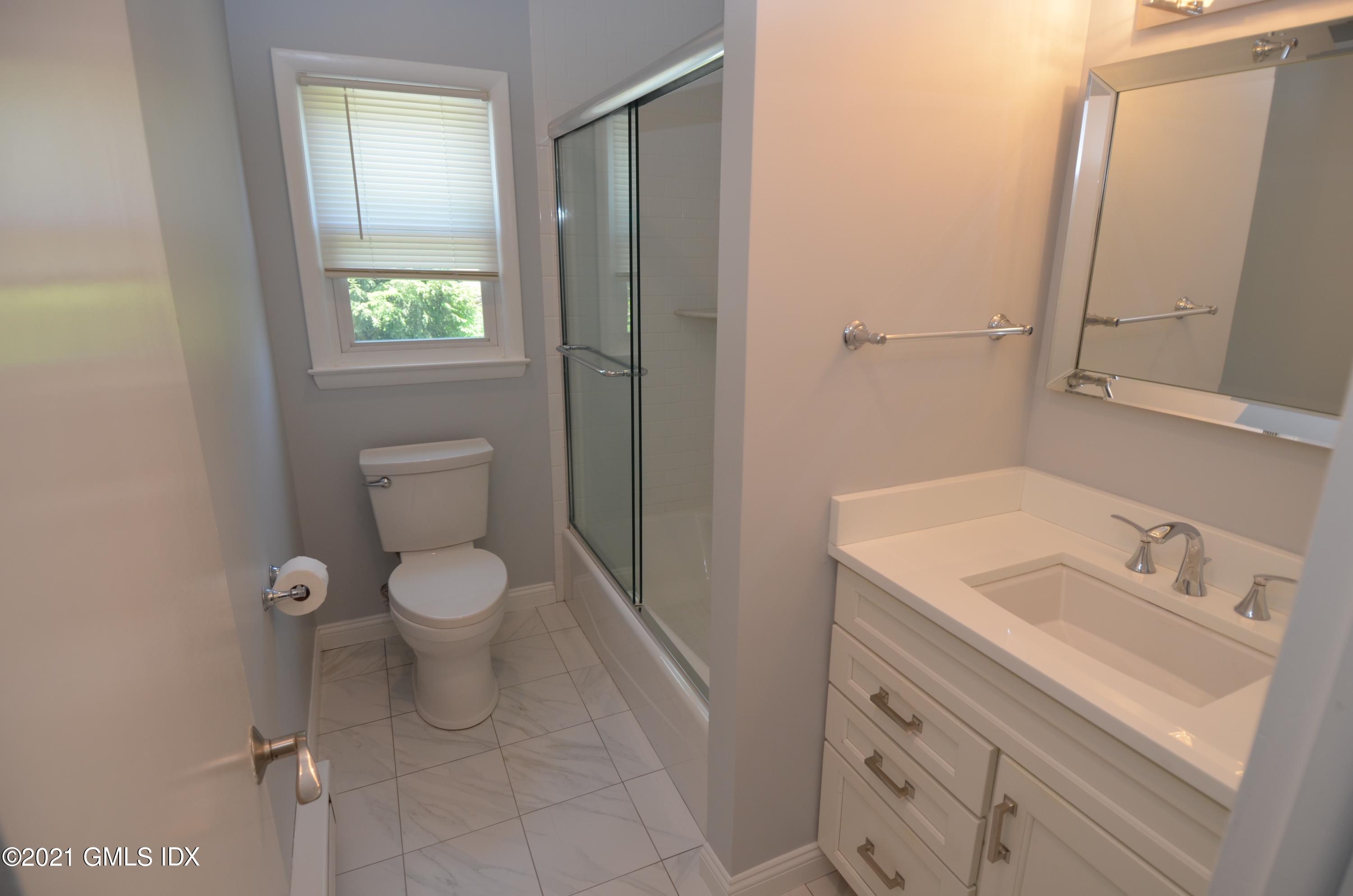 5 Ridge Place, Unit 1 Greenwich, CT 06831 - Photo 16 of 29 a bathroom with a toilet sink and mirror
