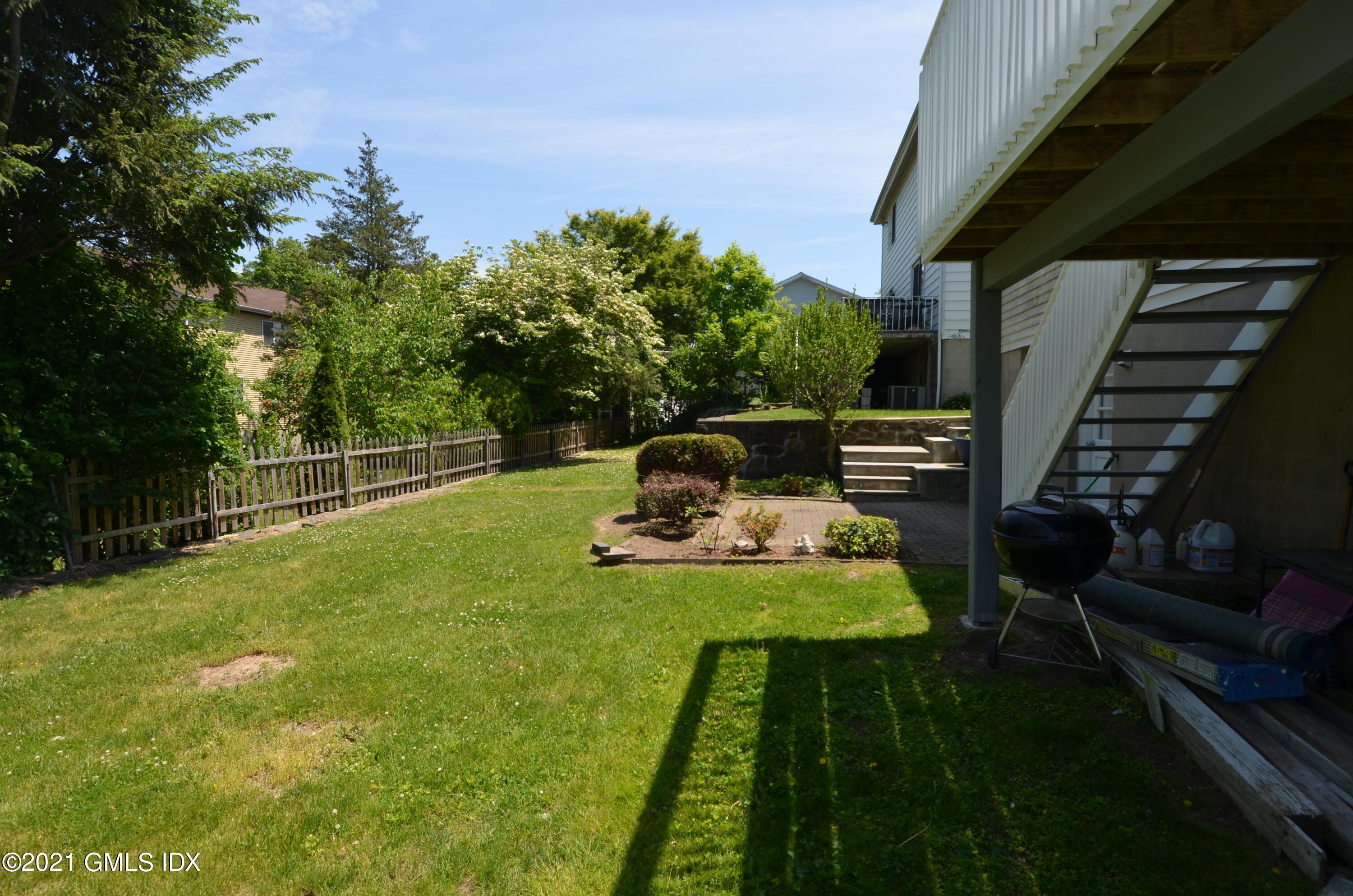 5 Ridge Place, Unit 1 Greenwich, CT 06831 - Photo 28 of 29 a view of a backyard with sitting area