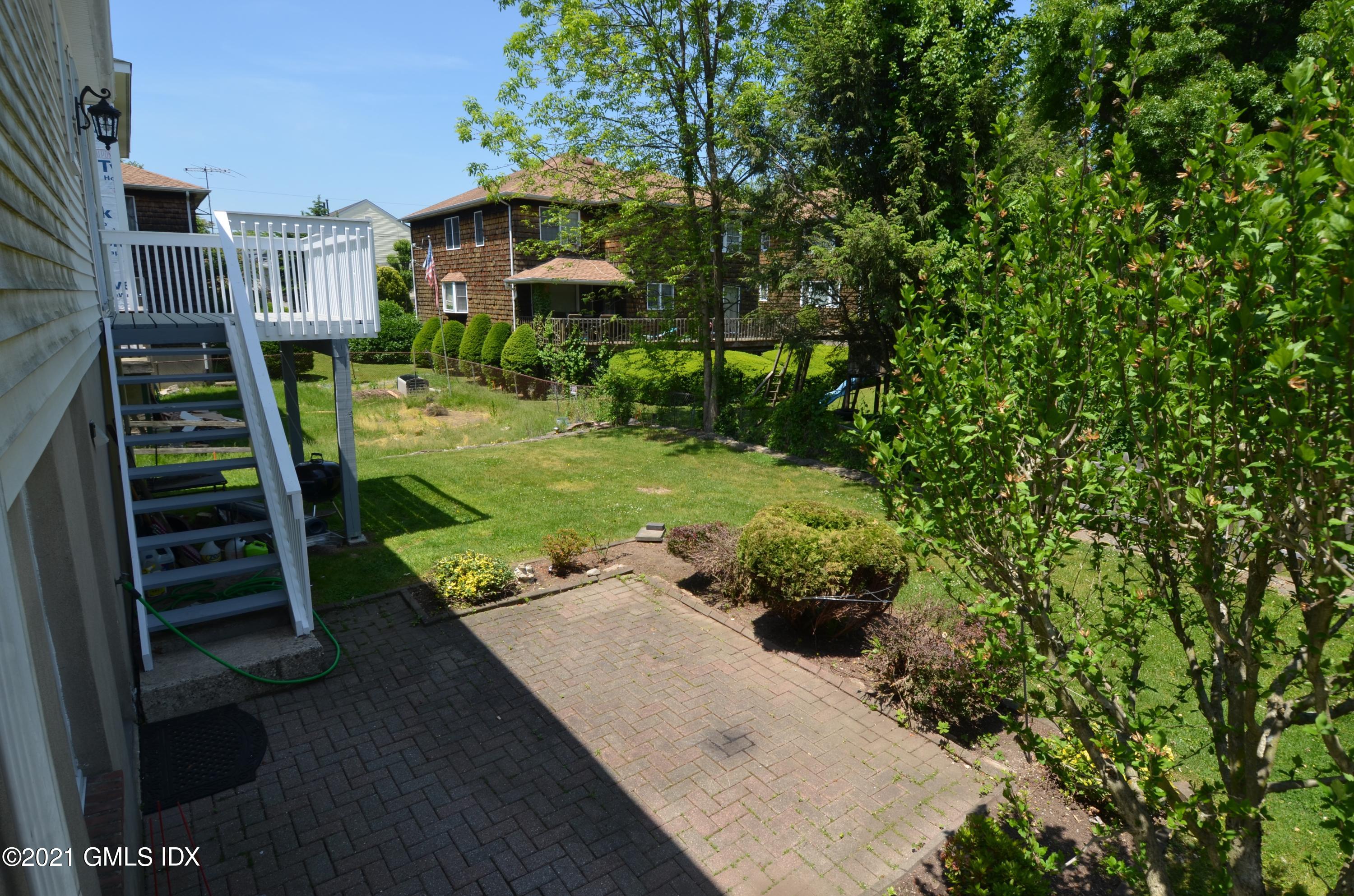 5 Ridge Place, Unit 1 Greenwich, CT 06831 - Photo 29 of 29 a view of a garden with a bench