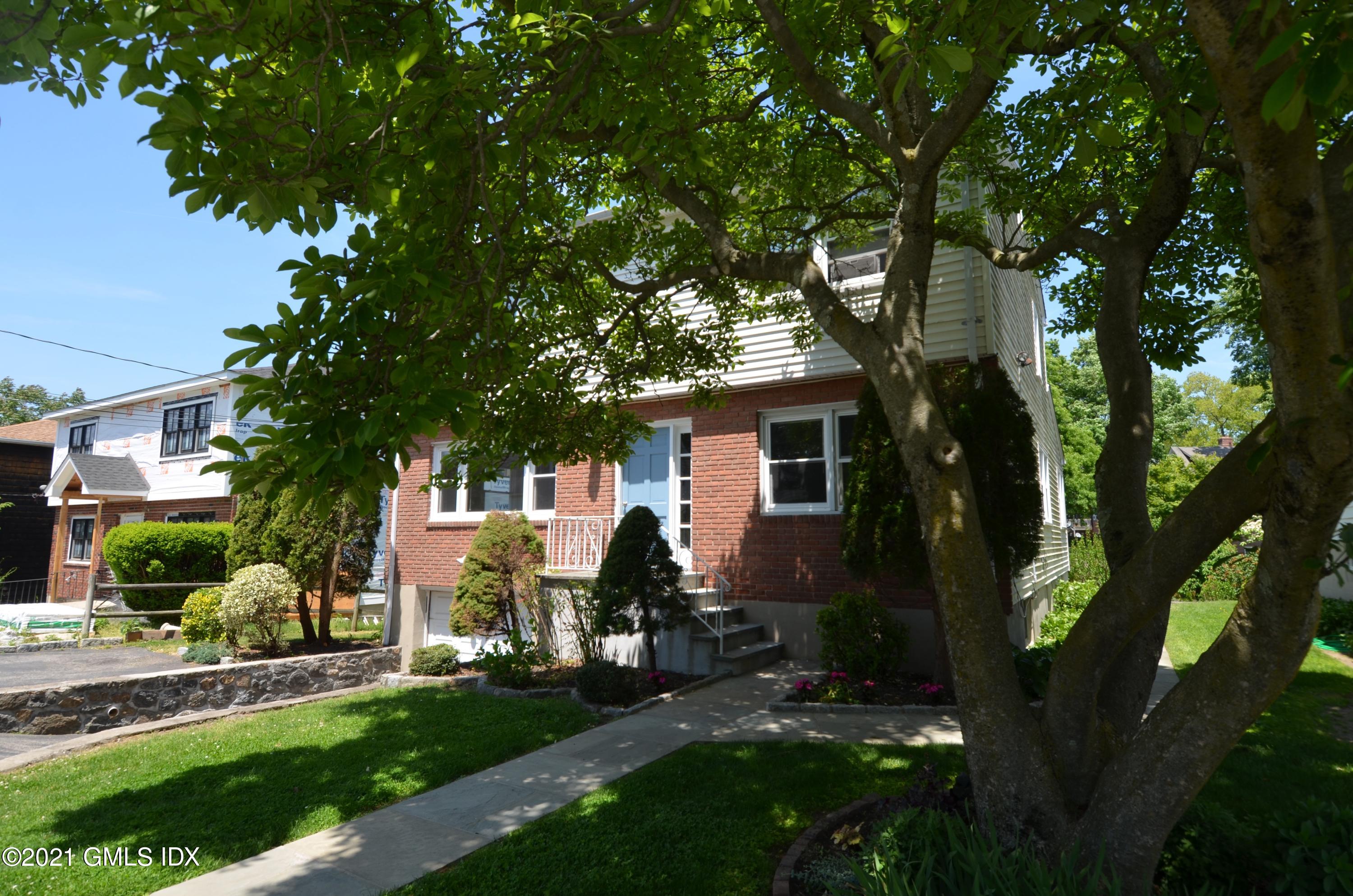 5 Ridge Place, Unit 1 Greenwich, CT 06831 - Photo 3 of 29 a view of house and yard with swimming pool and sitting area