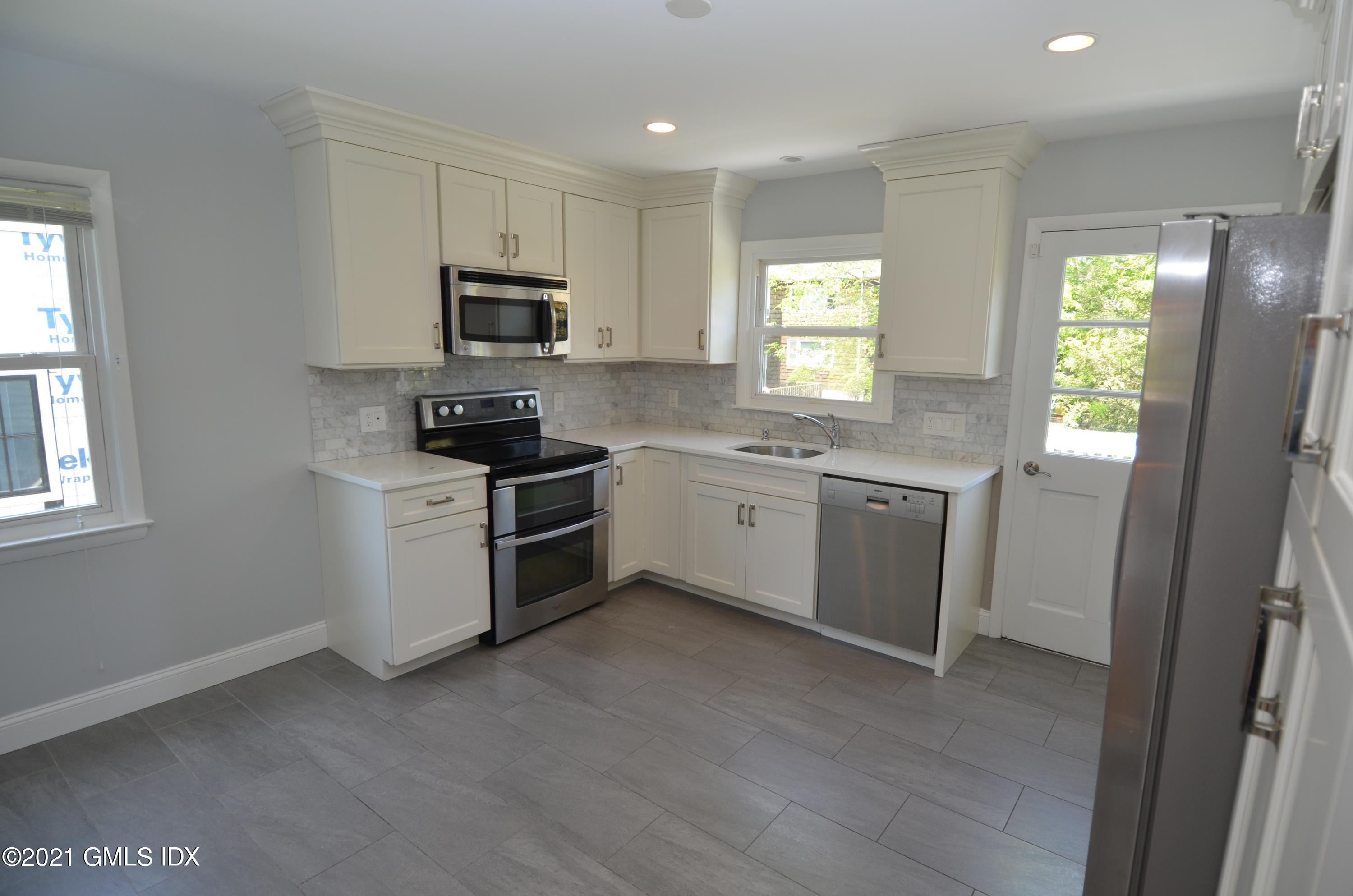 5 Ridge Place, Unit 1 Greenwich, CT 06831 - Photo 7 of 29 a kitchen with a sink a window and stainless steel appliances