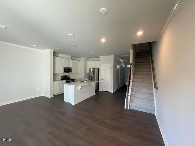 a view of kitchen with cabinets and wooden floor