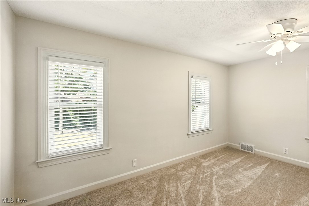2844 Kent Road Stow, OH 44224 - Photo 25 of 47 Spare room with light colored carpet, ceiling fan, and a textured ceiling
