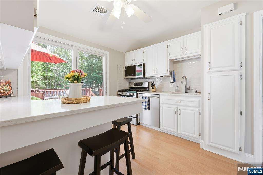 77 White Pond Road Waldwick, NJ 07463 - Photo 3 of 33 a kitchen with cabinets appliances and a window