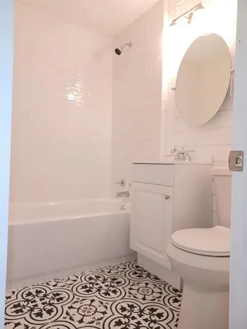 a bathroom with a toilet a sink and bathtub