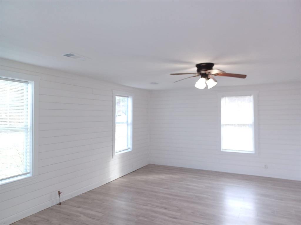 1309 South 5th Street Bonham, TX 75418 - Photo 4 of 8 wooden floor in an empty room with a window
