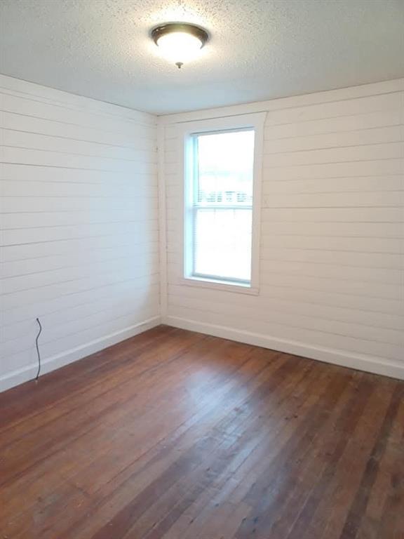 1309 South 5th Street Bonham, TX 75418 - Photo 5 of 8 an empty room with wooden floor and windows