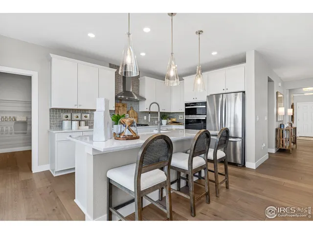 a living room with furniture and kitchen view
