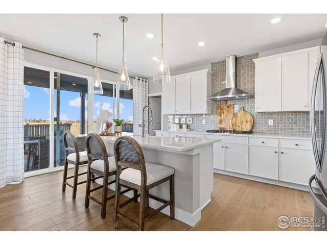 a living room with furniture a fireplace and a ceiling fan