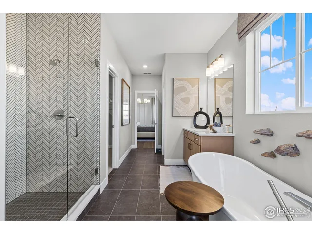 a spacious bedroom with a bed and a chandelier