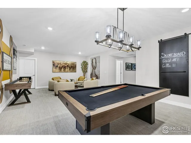 a room with pool table and windows