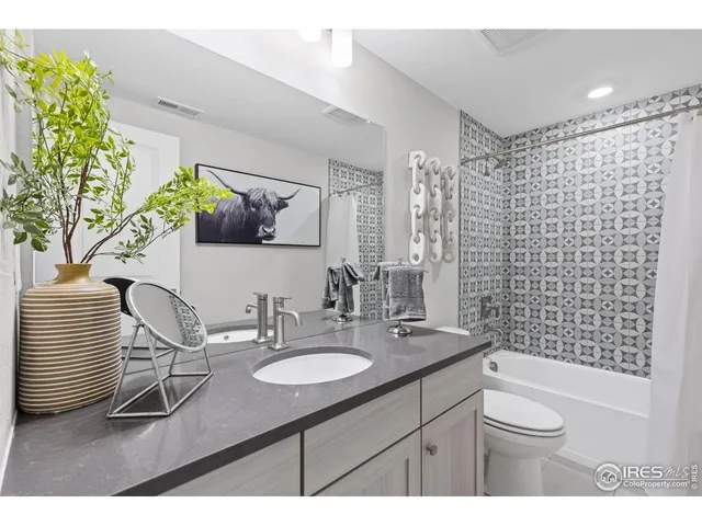 a living room with stainless steel appliances furniture and kitchen view